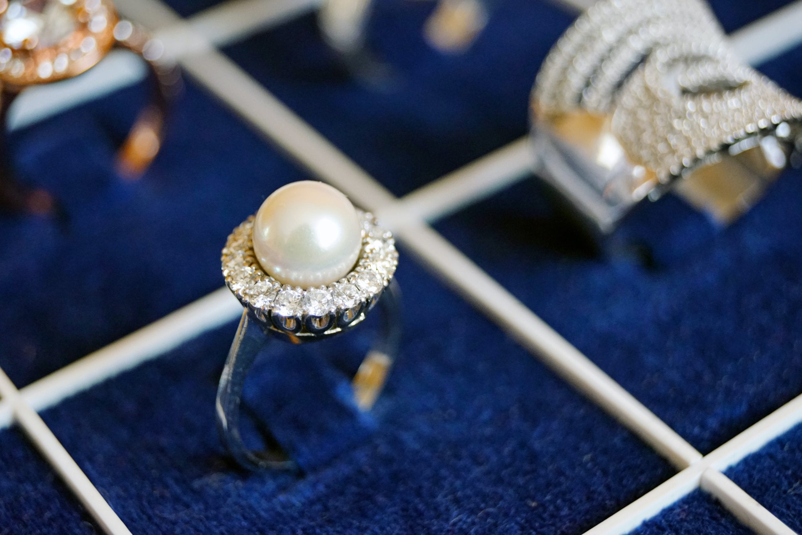 white-pearl-ring-on-blue-surface-1395305